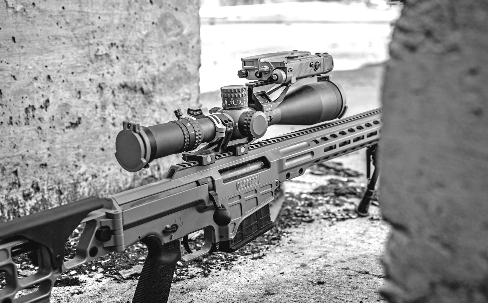 MK 22 with scope and clip-on night sight resting in a concrete position, black and white
