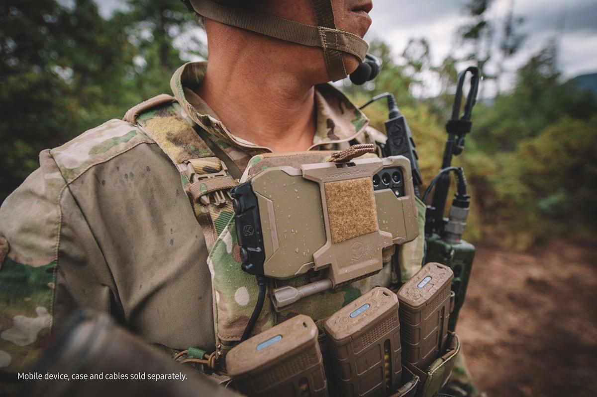 Soldier wearing a Tactical Edition phone in a chest mount on a plate carrier