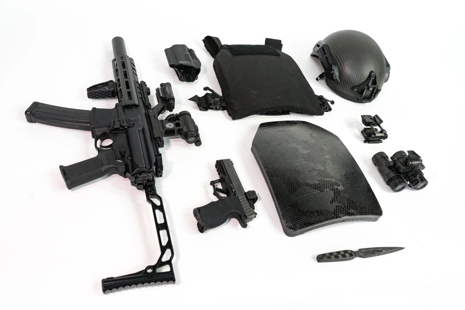 Plate shown with carrier, helmet, rifle and pistol on a white background